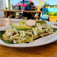 Huarache · home made corn thick tortilla cover with black refried beans your choice of meat of beef faj...