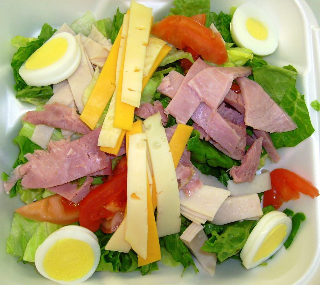 Chef Salad · Lettuce, tomatoes, black olives, ham, turkey, American cheese.