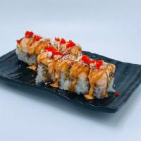 Ocean Roll · Spicy salmon, avocado, and crunch inside topped with seared salmon and masago.
