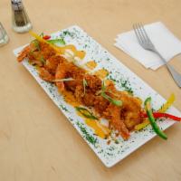Caribian Coconut Shrimp · Battered with toasted coconuts and deep fried. Served with a sweet Thai chili sauce 