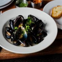 White Wine Mussels · White wine garlic sauce and French baguette.