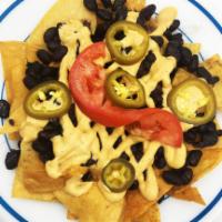 Nachos · Housemade chips with black beans, fresh red onions, pickled jalapeños, creamy cashew cheese ...