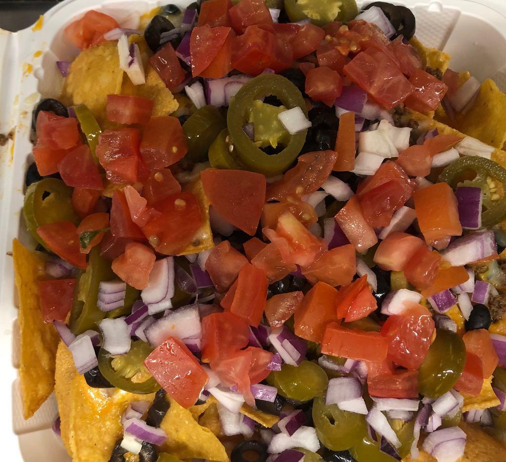 Pit Stop Nachos · Fresh tortilla chips smothered in cheese sauce with onions, tomatoes, jalapeno and black olives.