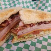 Club Sandwich · Double-decker roasted turkey, ham & bacon, Swiss & cheddar cheeses, lettuce and tomato. With...