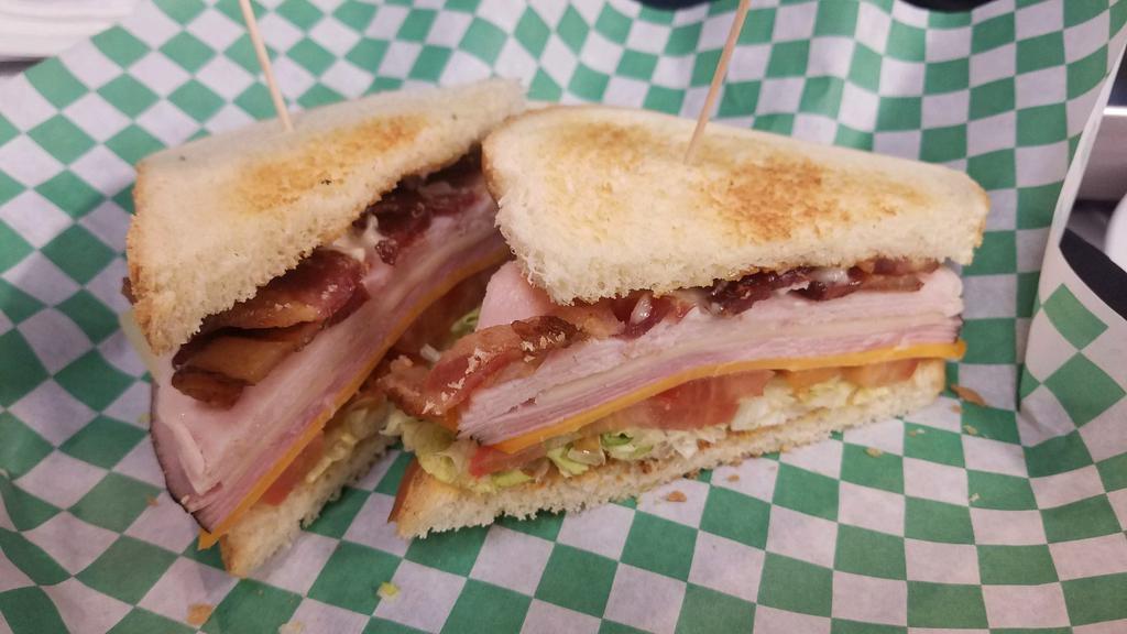 Club Sandwich · Double-decker roasted turkey, ham & bacon, Swiss & cheddar cheeses, lettuce and tomato. With your choice of chipotle or regular mayo on white, rye or wheat bread or as a wrap in a flour tortilla. 