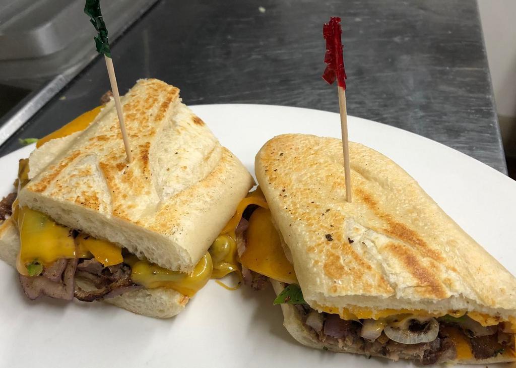 Philly French Dip Sandwich · Sliced beef grilled with onions and green peppers topped with melted cheddar cheese on a sourdough roll.