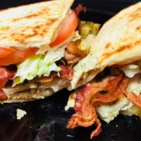 114. Chicken Club Panini · Grilled chicken, crispy bacon, Swiss cheese, lettuce and tomatoes.