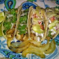 Traditional Taco · Topped with onion and cilantro. Limes and sauteed onion on side.