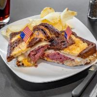 Reuben Sandwich · Thinly sliced pastrami with melted Swiss cheese, Kosher kraut, and 1000 Island dressing on t...