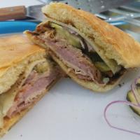 Cuban Sub · Ham, carnitas, turkey, Swiss cheese, pickles, and mustard on a pressed hoagie.