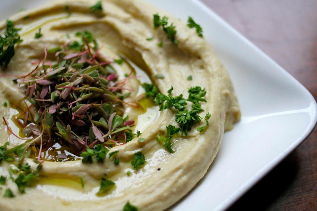 Hummus · Signature creamy dip of fresh whole chickpeas, tahini, garlic, fresh squeezed lemon juice, & Israeli extra virgin olive oil. Served with Pita Saag. 