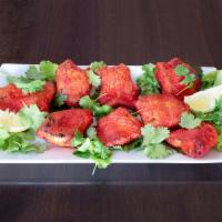 34. Fish Tikka Tandoori · Cubes of fish marinated with fresh herbs grilled in clay oven.