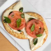Margherita Flatbread · Mozzarella, fresh basil and tomato, garlic, and extra virgin olive oil.