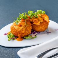 Shrimp Croquette · Creamy yucca croquette topped with Shrimps in Caribbean coconut sauce.