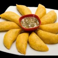 Beef and Chicken Empanada · Deep fried corn shells filled with
beef or chicken, potatoes,
tomatoes, onions, cilantro, se...