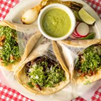 Tacos · Soft corn tortillas filled with choice of meat and topped with cilantro, onions and guacamol...