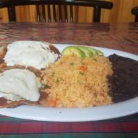 Huevos Rancheros · 2 Fried eggs on 2 corn tortillas topped with red or green sauce drizzled with sour cream and...