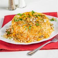 Vegetable Biryani · Long grain basmati rice cooked with fresh vegetables and safron sprinkled with raisins and n...