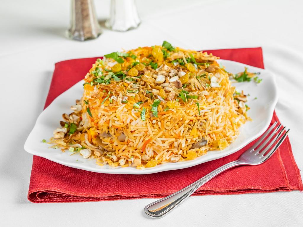 Vegetable Biryani · Long grain basmati rice cooked with fresh vegetables and safron sprinkled with raisins and nuts.