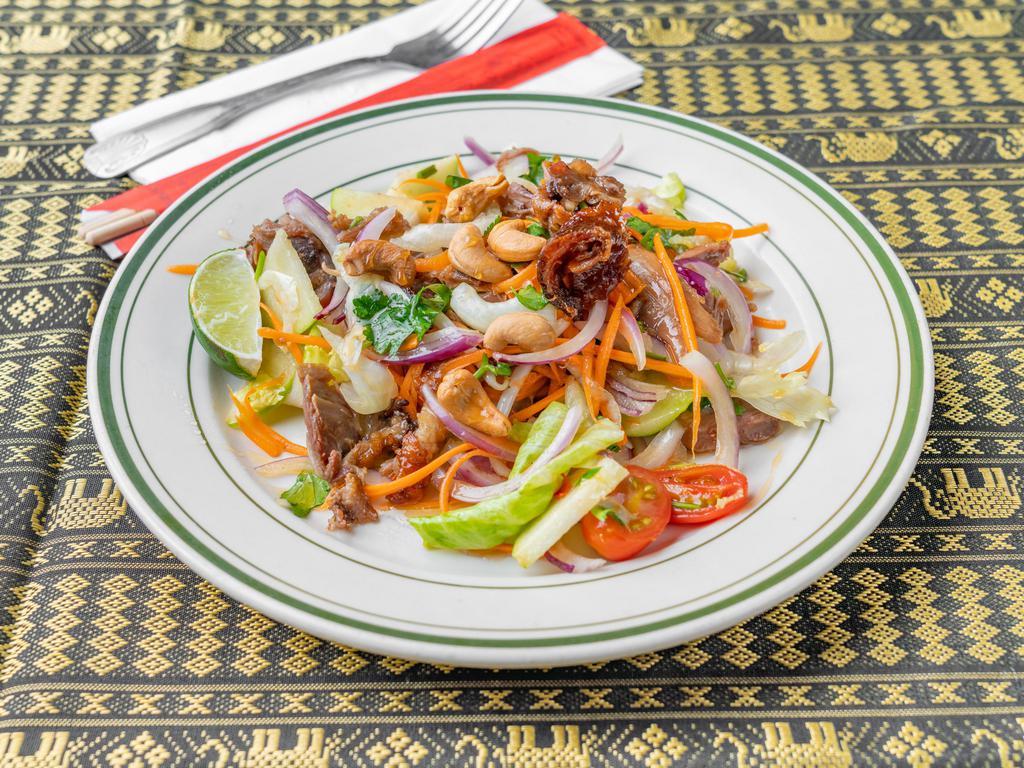 17. Crispy Duck Salad · Crispy duck, tomatoes, apple, cashew nuts and lime juice in chili sauce.