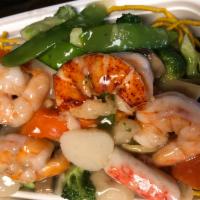 Seafood Bird Nest · Jumbo shrimp, scallop, crabmeat and lobster with vegetables in white sauce, and served in a ...