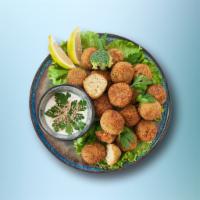 Falafel Fritters · 2 pieces. Mashed chickpea and fava bean mix, seasoned with fresh herbs and pan-fried crisp.
