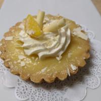 Lemon Tart · A buttery tart shell filled with lemon curd and topped with a rosette of white chocolate mou...