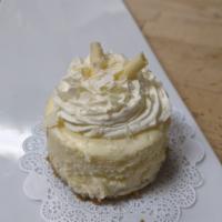 Classic Plain Cheesecake · A traditional plain baked cheesecake on a graham cracker crust, topped with white chocolate ...
