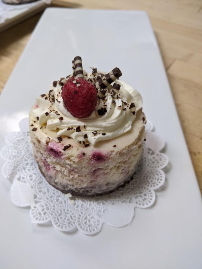  Raspberry Cheesecake · A raspberry cheesecake on a chocolate crust, topped with white chocolate mousse 