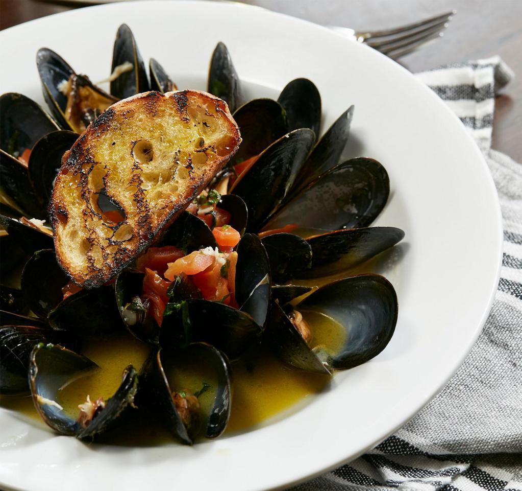 Steamed Mussels · Mussels steamed in white wine, garlic and cherry tomatoes..
