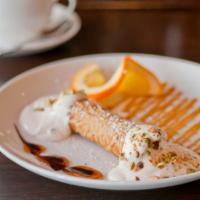Creamy Cannoli · Whipped ricotta, bittersweet chocolate chips, and pistachios stuffed into a light crisp cann...