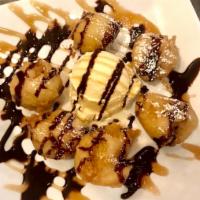 Fried Banana · Fried banana served with a scoop of vanilla ice cream and drizzled with caramel and chocolat...