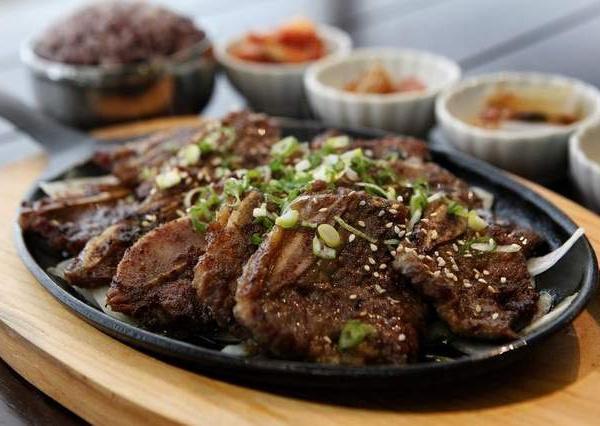 19. Beef Short Rib (Galbi) · Grilled beef short ribs marinated with a garlic soy sauce. Served with side of rice, doenjang sauce, and banchan.