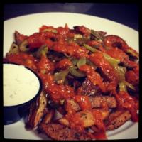 Suicide Fries · Featured on DDD. Hot peppers, garlic habanero sauce and served with Naked City ranch. Vegeta...