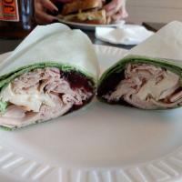 Turkey Wrap · Brie cheese, cranberries, and mixed greens on a spinach wrap.
