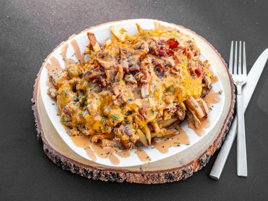 Bacon Cheeseburger Fries · Our fresh cut fries topped with seasoned ground beef, crispy bacon pieces, cheddar cheese, and our famous smokey aioli sauce.