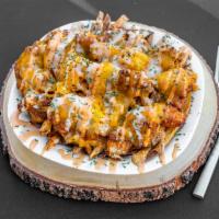 Chicken & Cheddar Fries · Our fresh cut fries topped with crispy chicken fingers, chives, cheddar cheese, and drizzled...