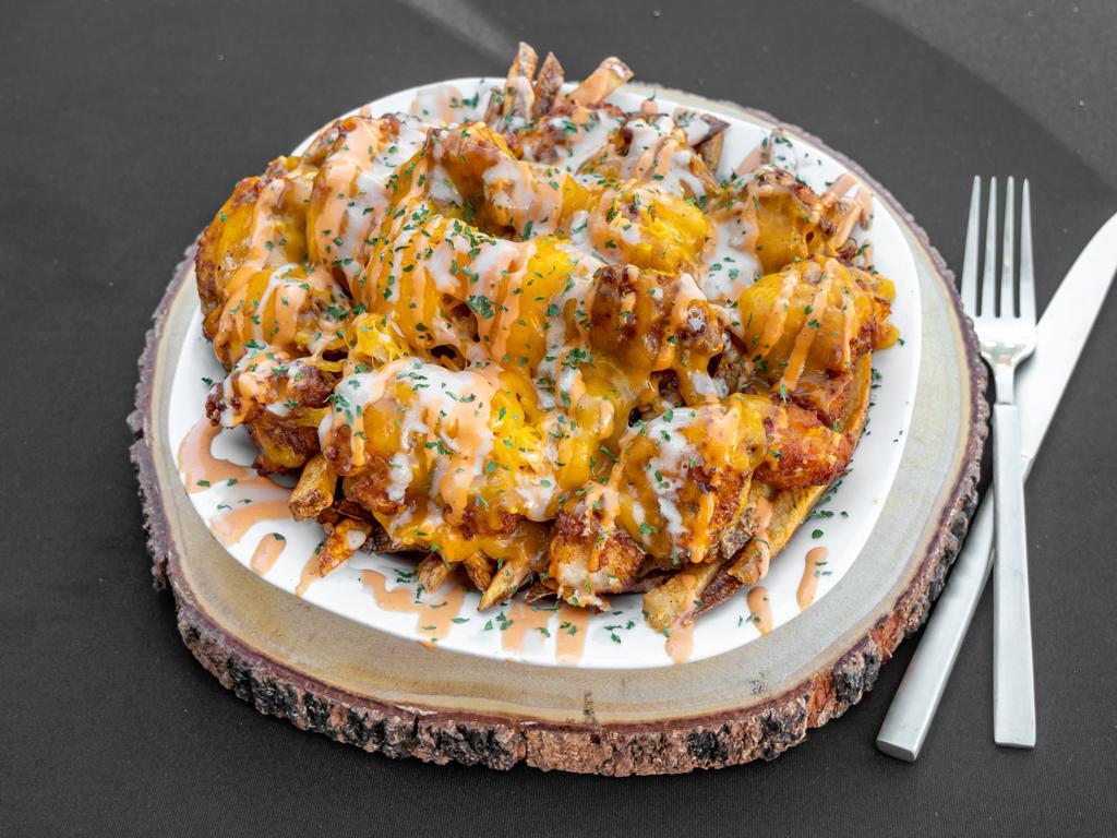 Chicken & Cheddar Fries · Our fresh cut fries topped with crispy chicken fingers, chives, cheddar cheese, and drizzled with our famous smokey aioli and our famous fry sauce.