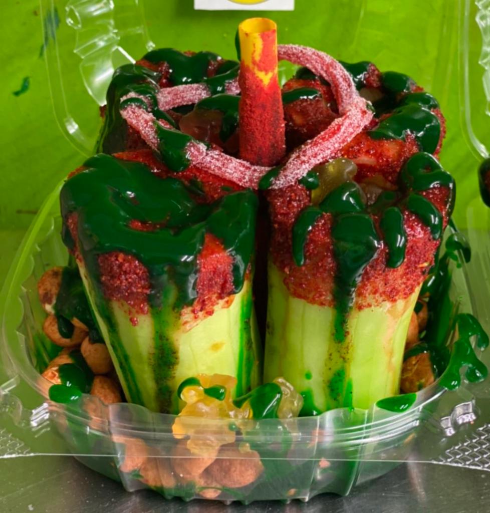 CRAZY CUCUMBER  · CUCUMBERS DIPPED IN LEMON JUICE AND LUCAS WITH CACAHUATES JAPONESES, GUMMY BEARS, SOUR STRIP, TAMARINDO STICK, RED CHAMOY, GREEN CHAMOY AND LUCAS 