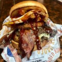 The BBQ Blue Burger · Made with two patties, blue cheese crumbles, onion ring, bacon, fried egg, and fried onions.