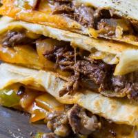 Ground Beef Quesadilla · Filled with ground beef, Onions,peppers &mix cheese. Served with nachos , Salsa & sour cream