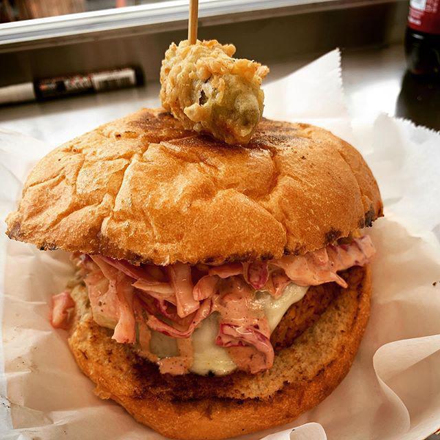 T&L Boudin Burger · A traditional boudin made with spicy, savory chicken, pork and rice seared as a patty with melted Havarti cheese, served on a toasted kaiser roll with cabbage slaw and remoulade sauce.