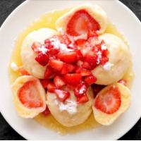 Strawberry dumplings with Champagne vanilla sauce · Champagne vanilla chaudeau, fresh berries and whipped cream.