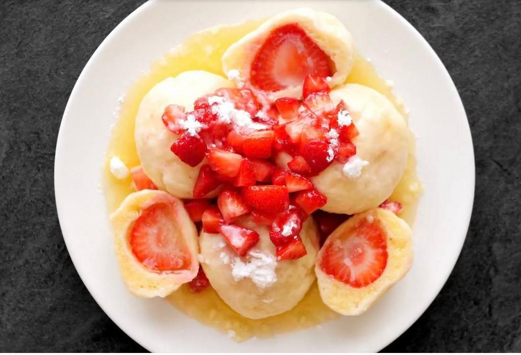 Strawberry dumplings with Champagne vanilla sauce · Champagne vanilla chaudeau, fresh berries and whipped cream.