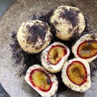 Plum dumplings with poppy seeds powder · Poppy seeds, fruit sauce and whipped cream.