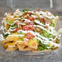 Nacho · Fresh corn tortilla chips loaded with queso and cheese, black, pinto or mashed beans, lettuc...