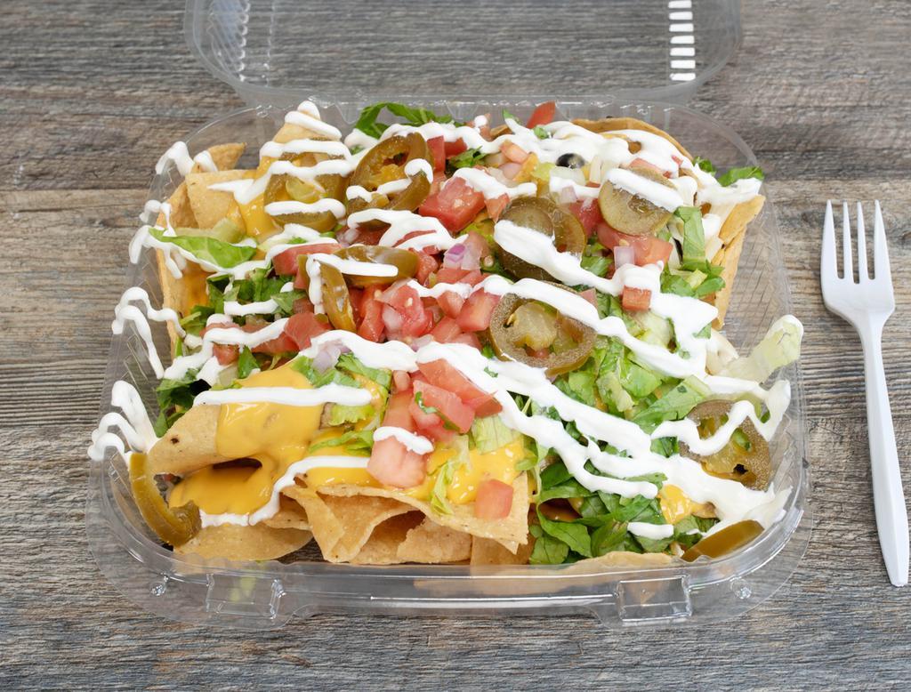 Nacho · Fresh corn tortilla chips loaded with queso and cheese, black, pinto or mashed beans, lettuce, pico de gallo, sour cream and jalapenos.