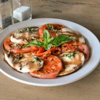 Caprese Salad · Mozzarella fior di latte and sliced fresh tomatoes topped with fresh basil.
