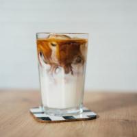 Iced Latte · Our signature sugar glider espresso brewed over milk and shaken with ice.