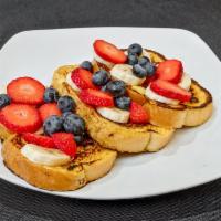 California French Toast · 3 pieces topped with powdered sugar, strawberries and bananas.